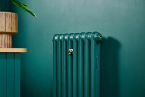 Emmeline I slimline cast iron radiator in Little Greene Goblin, installed in Chorlton, Manchester